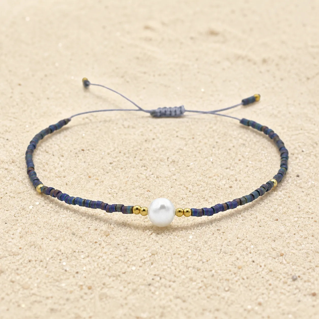 Seed bracelet on light sand