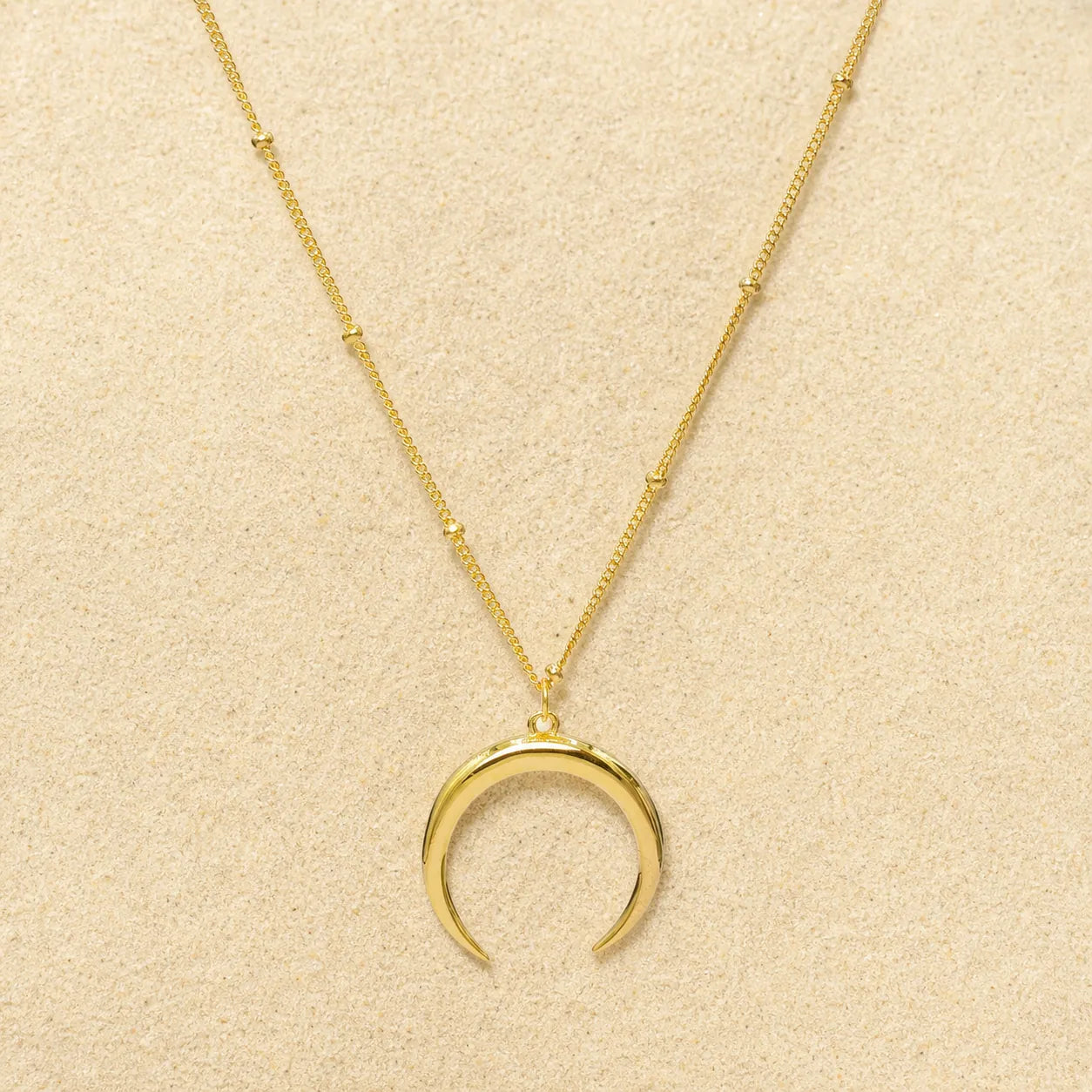 Crescent Necklace Gold on light sand