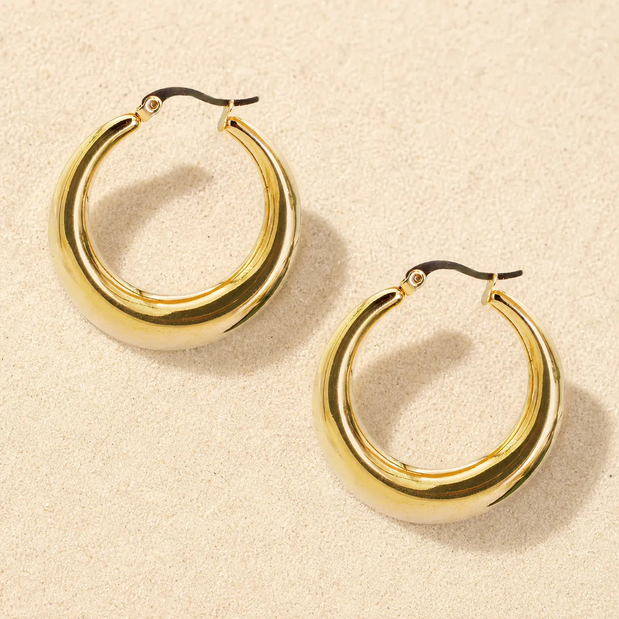 hoop earrings on light sand
