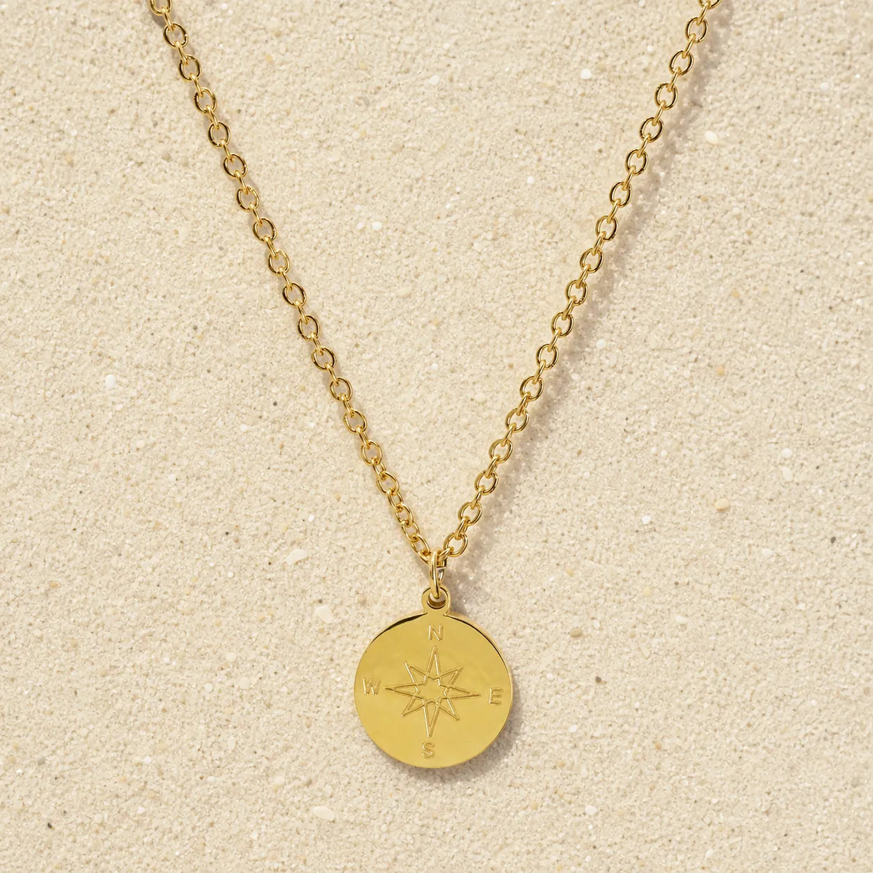 Compass Necklace Gold on light sand