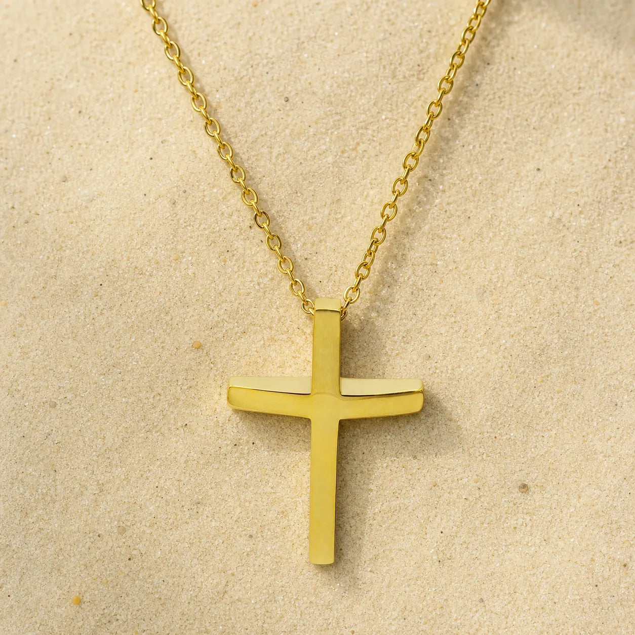 cross chain gold on light sand