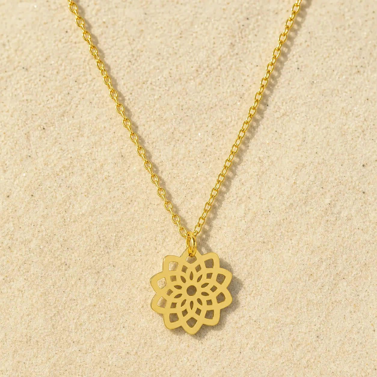 Flowers chain gold on light sand