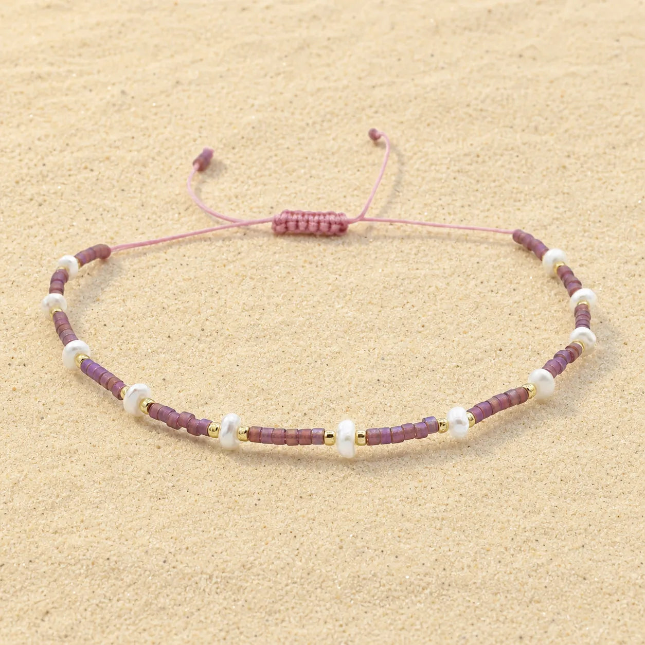Seed bracelet on light sand