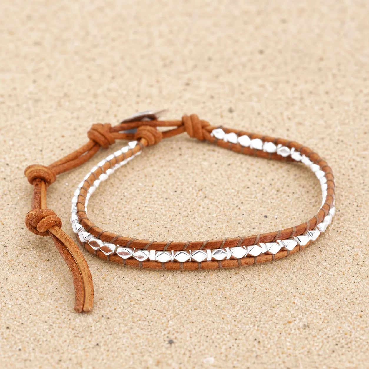 Filigree leather bracelet on light sand