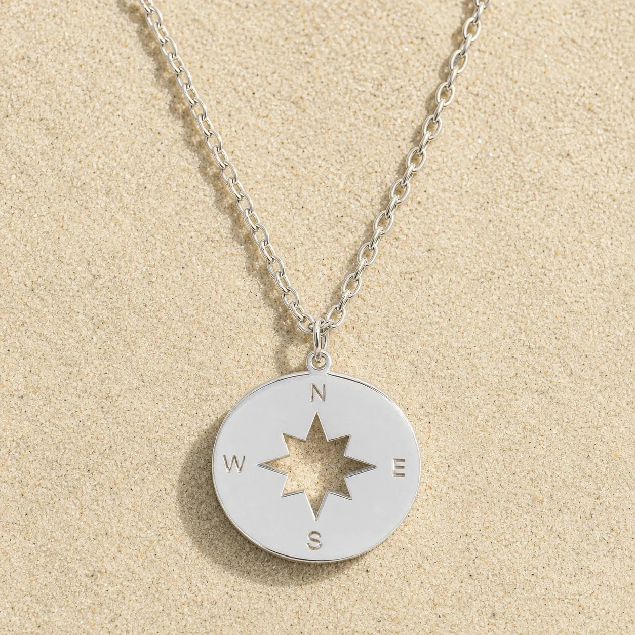 Kompass Kette Silber auf hellem Sand