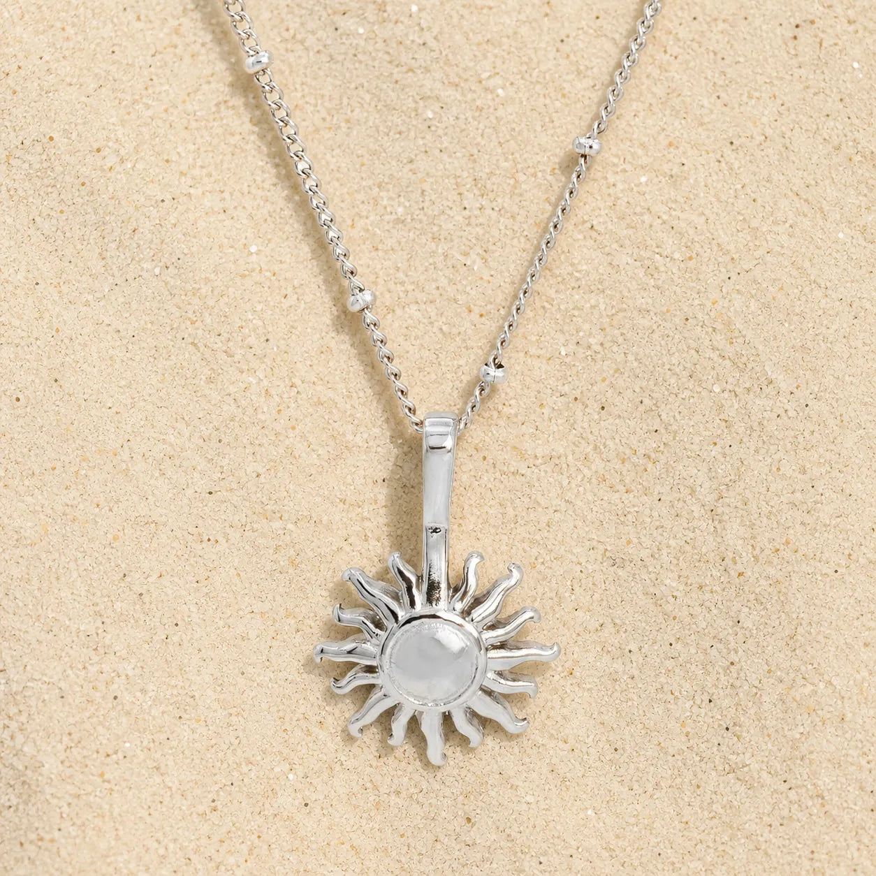sun necklace silver on light sand