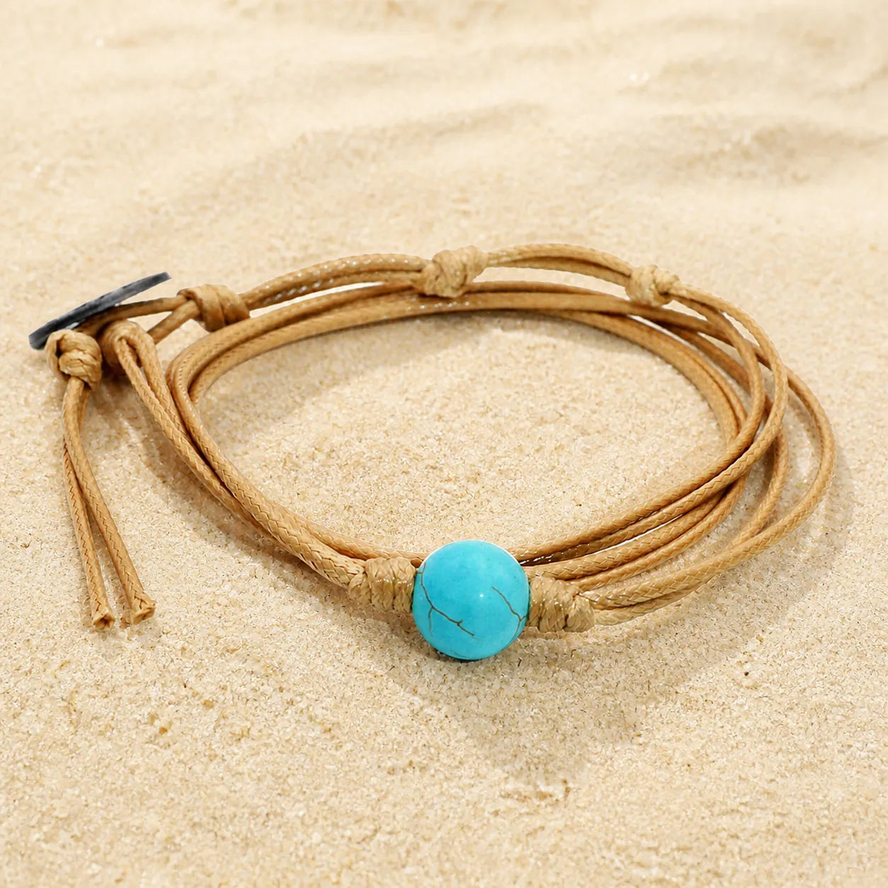 Turquoise Wax Cord Bracelet on light sand